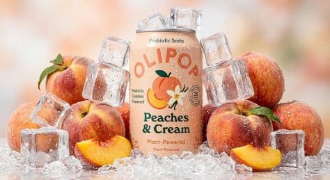 Chilled pastel peach aluminum soda can floating weightlessly among sliced ripe peaches and swirling fresh cream ribbons.