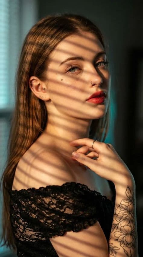 Close-up portrait of a young woman with glowing sunlit skin and soft freckles at golden hour