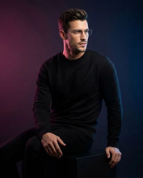 A refined editorial portrait of a poised man in subject sideways on front under cinematic lighting.