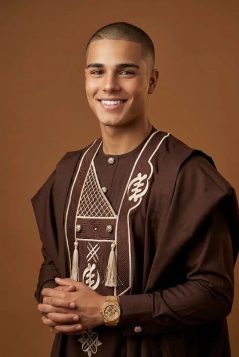 Handsome young man with a crisp buzz-cut posing confidently under balanced studio softboxes