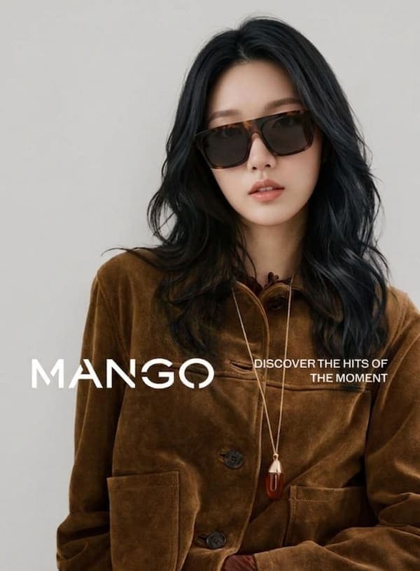 A high-end fashion editorial portrait of a young East Asian woman in a suede jacket and denim outfit with soft studio lighting and minimalist magazine typography reading “MANGOâ€.