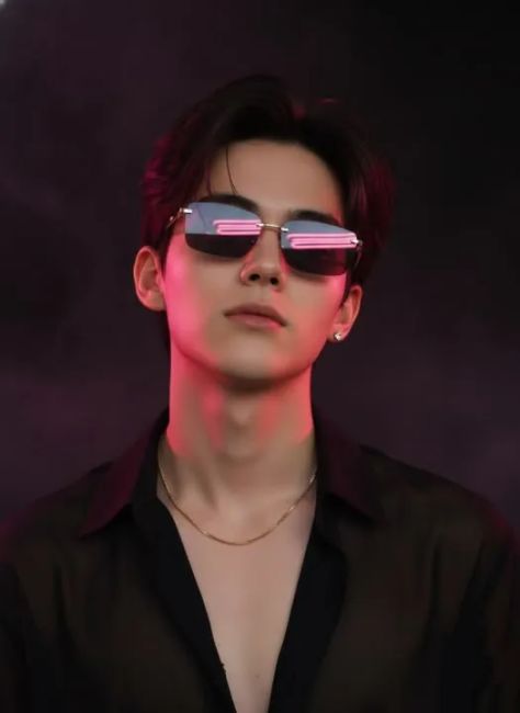 A photorealistic dark cinematic editorial portrait of the same young adult from the uploaded reference wearing narrow rectangular dark sunglasses with neon-pink reflections, a black semi-sheer open-collar shirt, fine gold jewelry, and deep espresso hair against a plum-black studio backdrop with vivid magenta accent lighting.